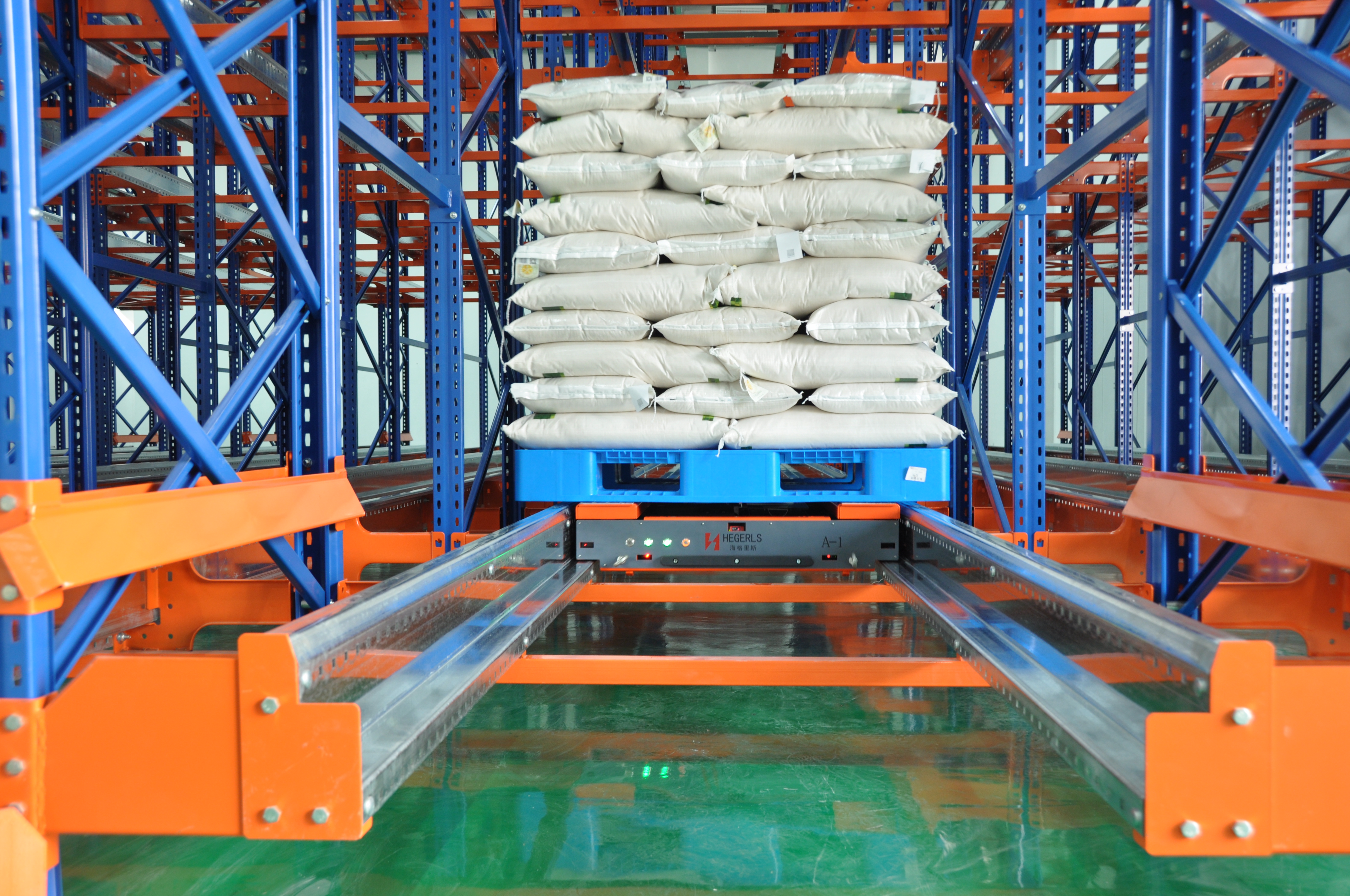 Pallet shuttle moving pallets inside deep-lane storage racks